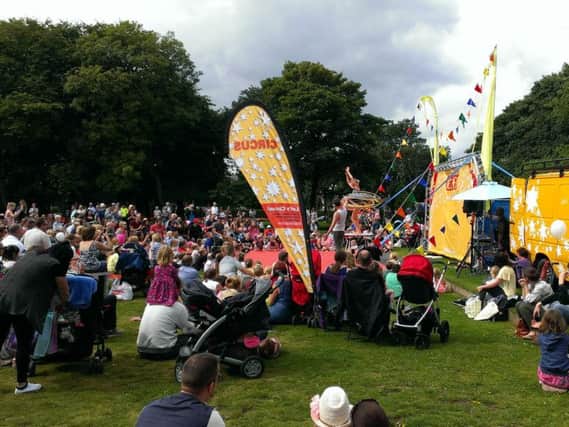 A large crowd enjoy a circus skills show in Ridley Park.