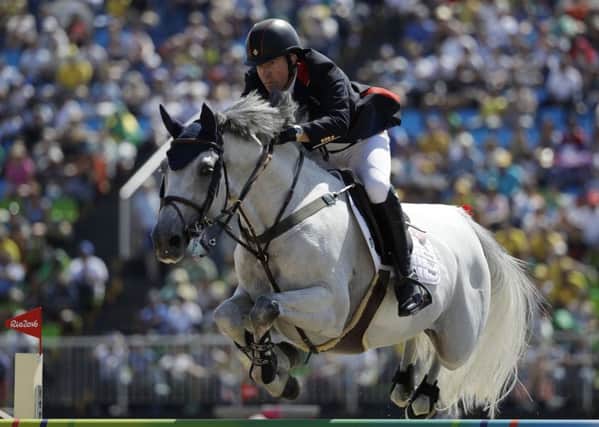 Britain's Michael Whitaker, riding Cassionato, competes in the equestrian jumping competition at the 2016 Summer Olympics in Rio.