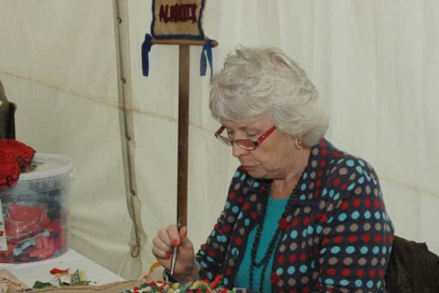 Mary Learmouth, of Alnwick, demonstrates proggy and clippy mat making. Picture by Mary Scott