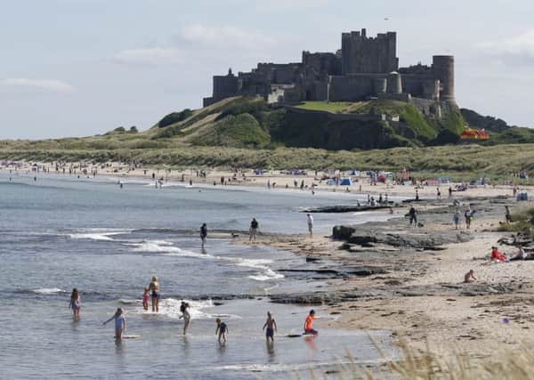 People enjoying the sunshine at Bamburgh Castle. Picture by Owen Humphreys/PA Wire