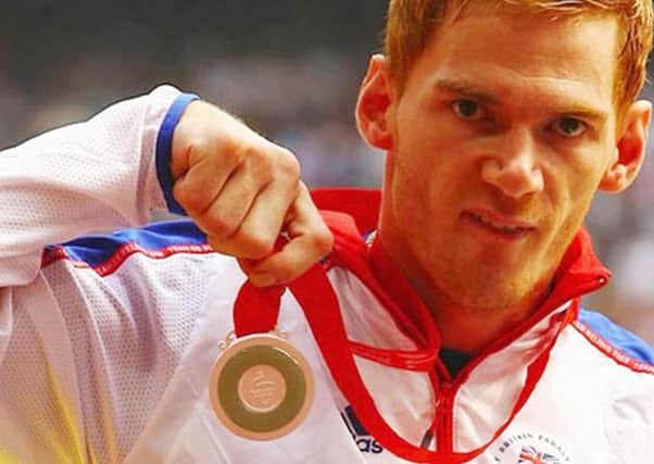 Stephen Miller with the medal he won at the Beijing Paralympics in 2008.