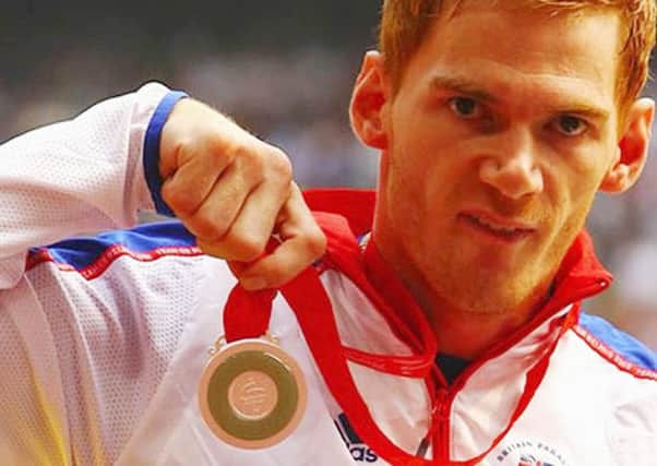 Stephen Miller with the medal he won at the Beijing Paralympics in 2008.