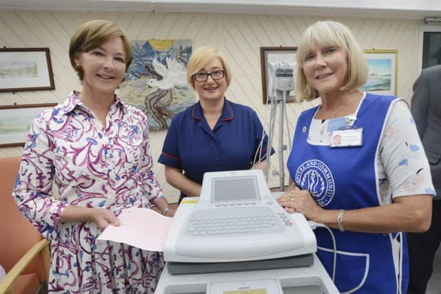 The Duchess of Northumberland presents an ECG machine to Matron Annaluisa Wood watched by Anne Harper, chairman of the League of Friends. Picture by Jane Coltman