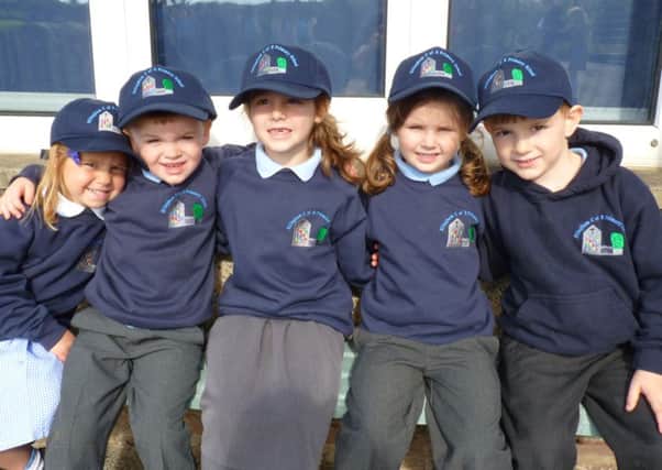 Pupils at Ellingham CofE Primary School wearing their new caps.