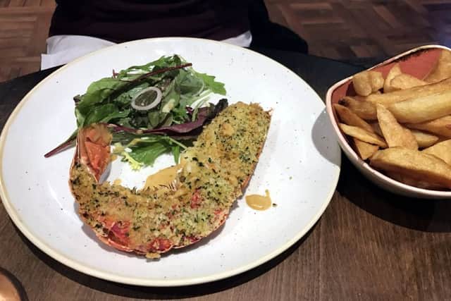 Half a lobster with lobster cream sauce, herb crumb, chips and salad at the Jolly Fisherman at the Quayside, Newcastle.