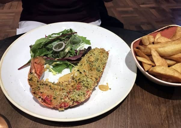 Half a lobster with lobster cream sauce, herb crumb, chips and salad at the Jolly Fisherman at the Quayside, Newcastle.