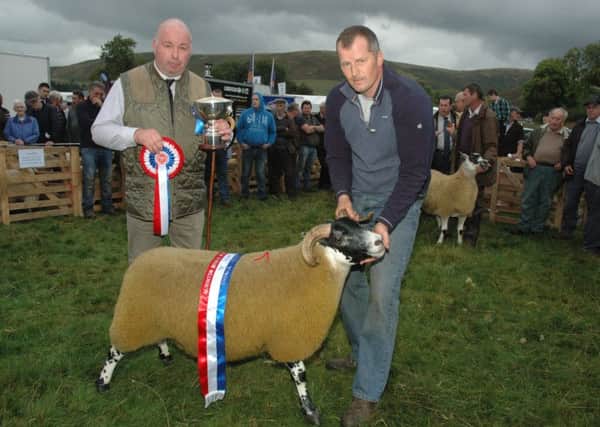 Steven Mackay won numerous trophies at the show. Here he is presented with the Tom Mackay Rose Bowl Overall Champion trophy, which is named after his father. The cup was presented by Andrew Walton. Picture by Mary Scott.