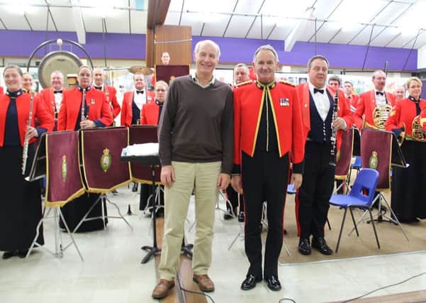 Rotary Club of Amble and Warkworth president Stephen Kerry with director of music Major Kevin Crook and the band of the Royal Regiment of Fusiliers.