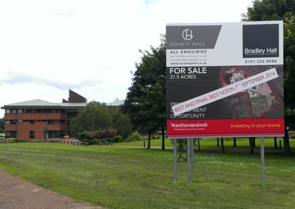 A for sale sign at the County Hall site in Morpeth, with part of the building in the background.
