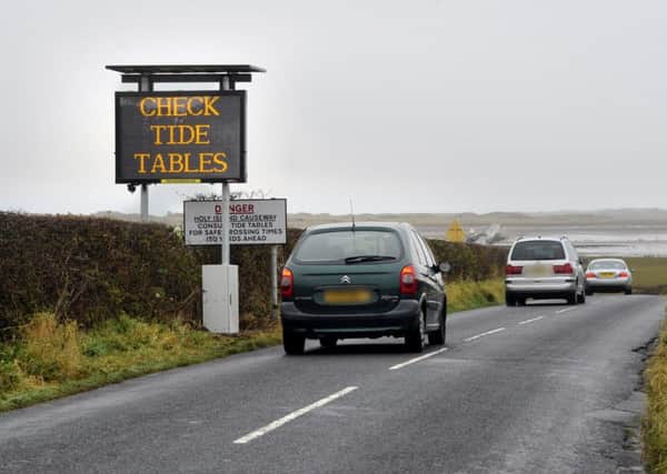 One of the signs on Holy Island encouraging people to check the tide times for the causeway.