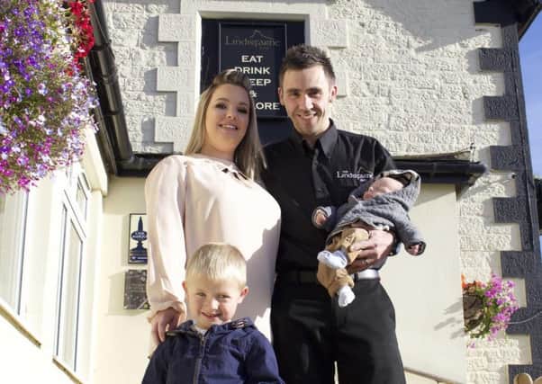 The Lindisfarne Inn's new general manager Chris Taylor with wife Leonie and children Dylan and Joey.