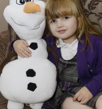 Evie Campbell with her Olaf the Snowman toy, from the Disney hit Frozen. Picture by Jane Coltman