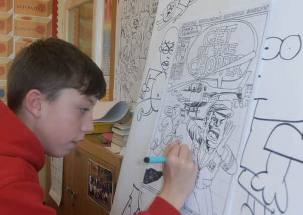 A Duke's Middle School pupil drawing a comic strip.