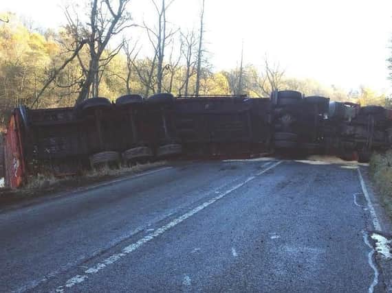 The overturned lorry has blocked the road.