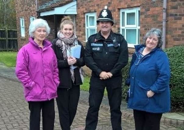 Pc Paul Mckenzie and Kayley Atkinson, Kingston Property Services property manager with local residents.