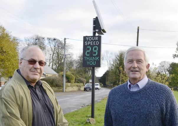 Coun Iain Elliott, chairman of Longhorsley Parish Council, and Coun Glen Sanderson with one of the speed signs in Longhorsley. Picture by Jane Coltman