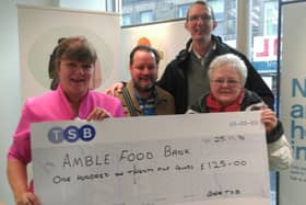 Suzanne Gair, local banker from TSB, presents the cheque to Amble Food Bank.