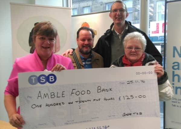 Suzanne Gair, local banker from TSB, presents the cheque to Amble Food Bank.