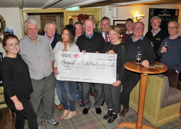 Members of The Coach Inn Onion Club, Lesbury, presenting
a cheque to  Hospice Care