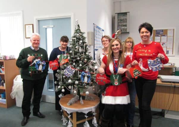 The prison's Business Hub team wearing their jumpers and spreading festive cheer. From left: Stephen Dargue, Michelle Stansfield, Claire Clark, Allison Thompson and Sarah Potts, with Lorna Stewart-Hook at the front.