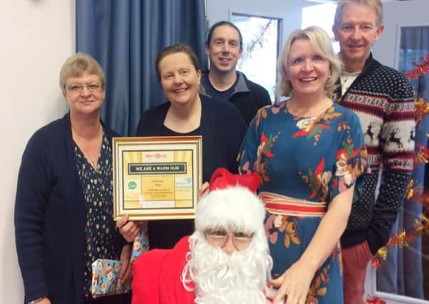Shirley Wright, holding certificate, from Seahouses Development Trust, with Christine Nicholls, second right, CAN community development officer, and guests at the Seahouses Warm Hub Christmas party.