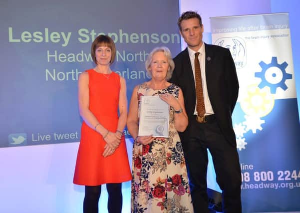 Lesley Stephenson receiving her national Volunteer of the Year runner-up certificate from double Olympic gold medallist and Headway UK Vice President James Cracknell with Jackie Spinks from award sponsor, Anthony Gold Solicitors.