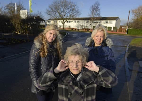 Coun Alison Byard and Stobhill residents Pauline Rogerson and Nora Gore, with Choppington Road in the background. Picture by Jane Coltman.