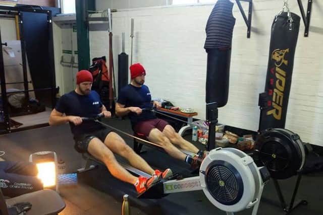 Two of the team on the rowing machine at Real Fitness gym, in Alnwick.