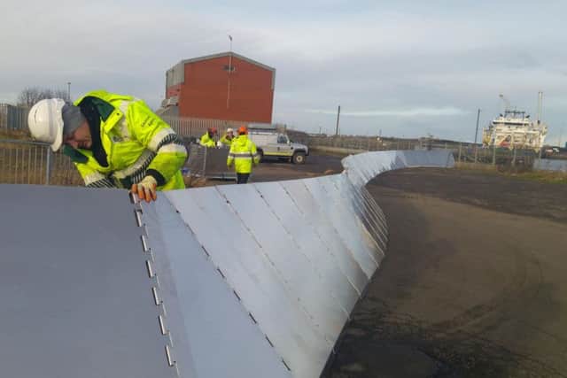 Environment Agency workers erect temporary barriers at Winbourne Quay, Blyth. Picture by Jane Coltman