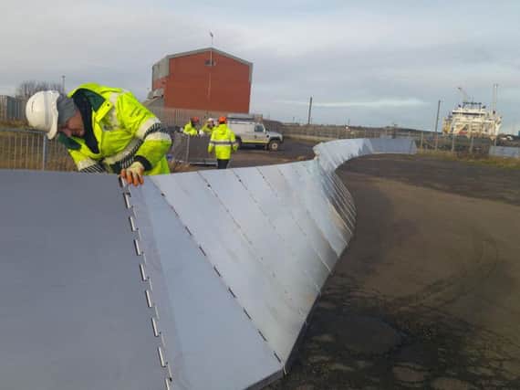 Environment Agency workers erect temporary barriers at Winbourne Quay, Blyth. Picture by Jane Coltman