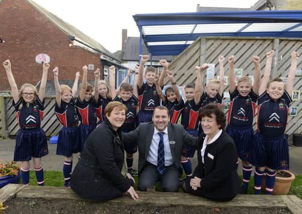 Cookswell Garage has presented Pegswood Primary School with new sports kit. Headteacher Andrew Waterfield is seen with Claire Brind, left, and Julie Stephenson from the Citroen garage and some delighted pupils.  Picture by Jane Coltman.
