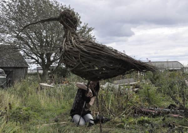 Willow Sculptor Anna Turnbull completing a willow Curlew.