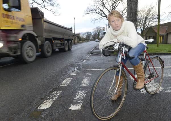 Councillor Kate Cairns standing with her bicycle in Longhoughton where she wants to intoduce advisory cycle lanes.
 Picture by Jane Coltman