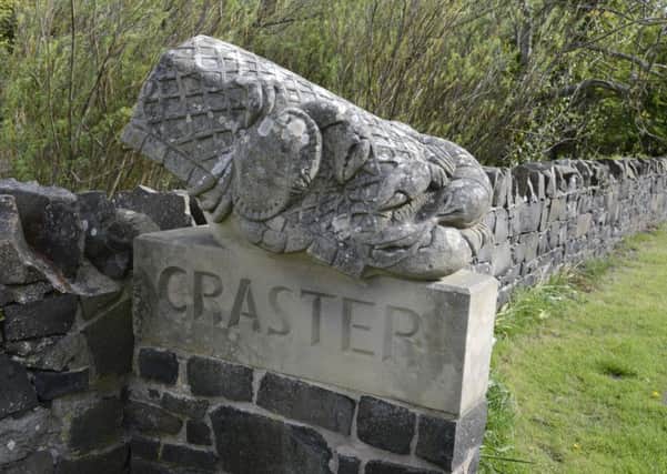 The stone carving at the entrance to Craster.
Picture by Jane Coltman