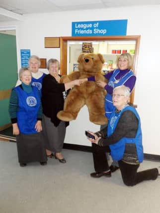 The chairman, Anne Harper, and members of the League of Friends of the Alnwick Hospital, pictured presenting the Teddy Bear to a delighted Mrs Enid Brown from Alnwick.