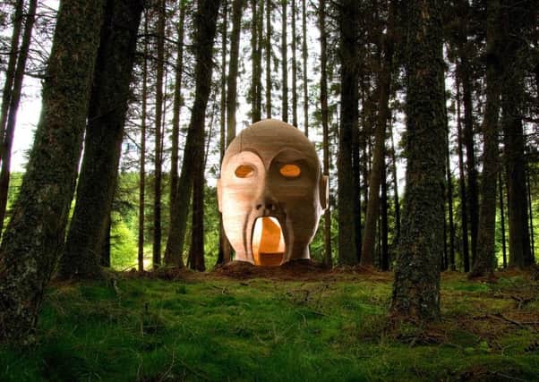 One of the artworks around Kielder Water, a giant timber head, called Silvas Capitalis created by a group of American sculptors called SIMPARCH. Photo - Kielder Water & Forest Park Development Trust.