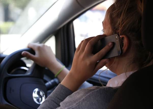 Police are clamping down on drivers who use their mobile behind the wheel.
