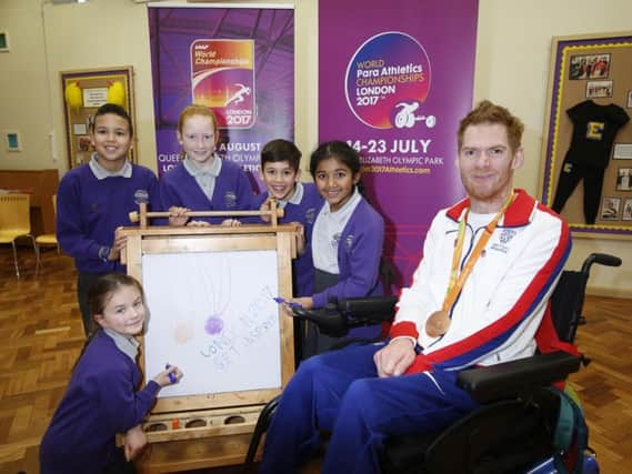 Paralympian Stephen Miller with youngsters at his surprise school visit.