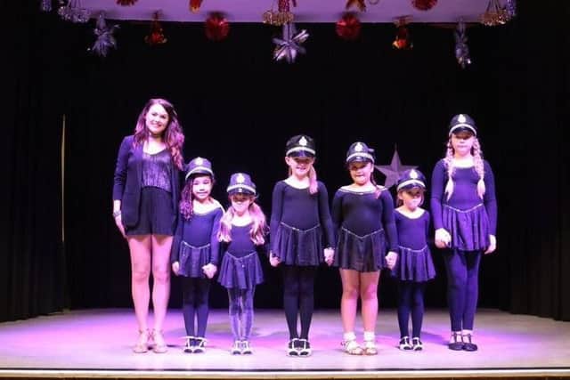 Lisa Fiddes-Dobson, left, with one of her childrens classes that performed during the Night at the Movies show.