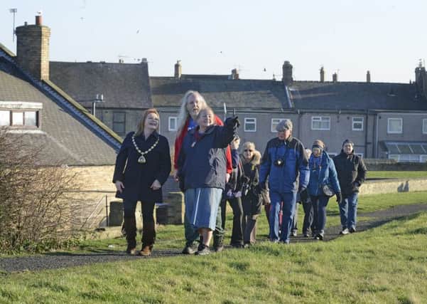 Walking along the Amble History Trail.
 Picture by Jane Coltman