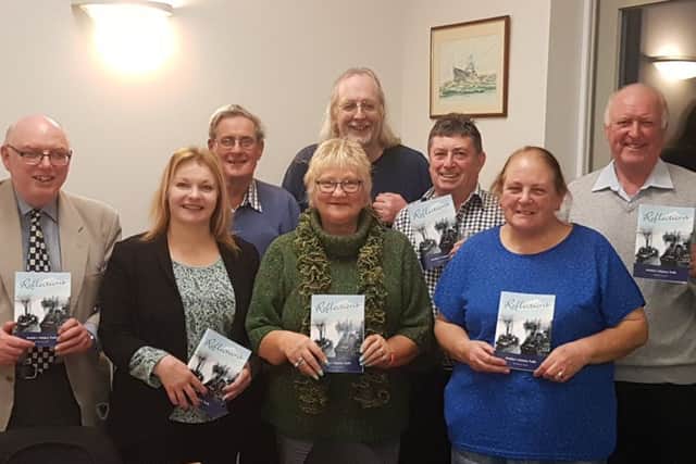 Amble councillors with the Reflections book.