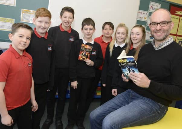 Author and artist Niel Bushnell with pupils at Seahouses Middle School.
 Picture by Jane Coltman