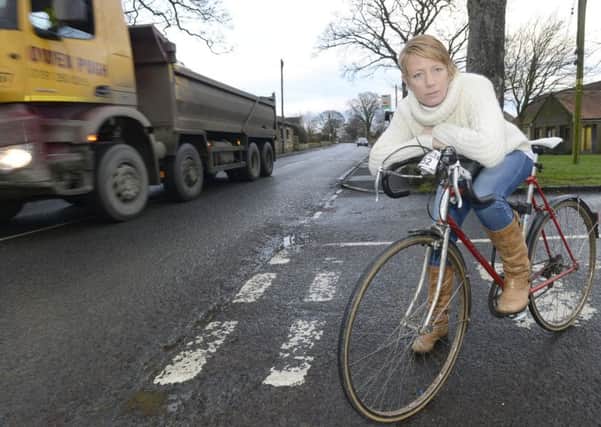Coun Kate Cairns with her bicycle in Longhoughton where she wants to introduce cycle lanes and reduce the speed limit through the centre of the village.  Picture by Jane Coltman