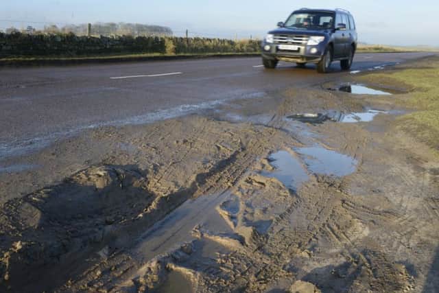 Potholes on the outskirts of Seahouses where people park to access the dunes and beach.