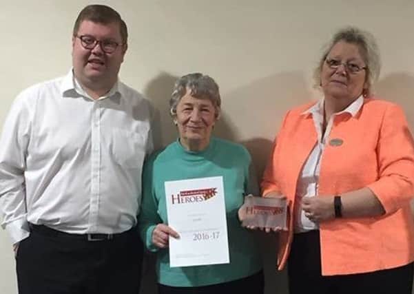 Joan Miller, centre, is pictured with her award, along with Coun Liz Simpson and Coun Scott Dickinson.