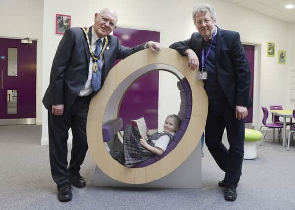 Mayor Alan Symmonds, left, with pupil Annabel Samuels and chairman of governors Bill Grisdale in the new library at the official opening of the extension at Swansfield Primary First School.
 Picture by Jane Coltman