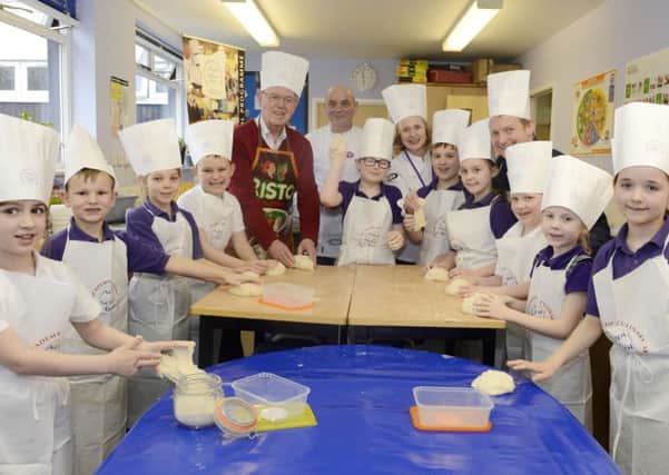 Pupils at Swansfield Primary School making bread with Ian Parsons, Tony Binks, Lucy Carroll and mayor Alan Symmonds.
Picture by Jane Coltman