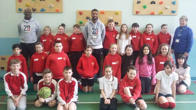 Gary Bennett and Richard Offiong visited the Duke's Middle School, in Alnwick, as part of the Show Racism the Red Card initiative. Alnwick county councillor Heather Cairns is also pictured.