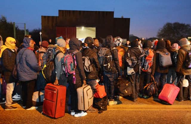 Migrants line-up to register at a processing centre in "the jungle" near Calais. Picture by John Stillwell/PA Wire.