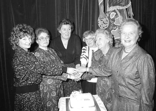 Remember when from 25 years ago, Alnwick and District Flower Club celebrate 25 years, past and present members are seen cutting the cake